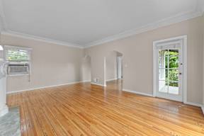 A room with wooden floors and white walls.