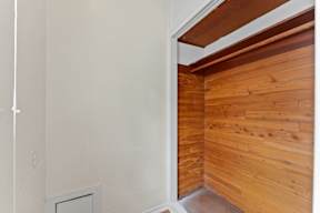 A room with a white wall and a wooden wall.