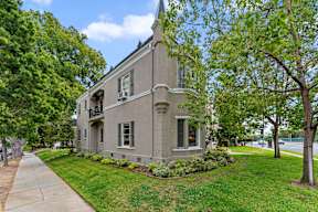 A two-story house with a balcony on the second floor.