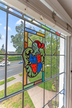 A stained glass window with a coat of arms design.