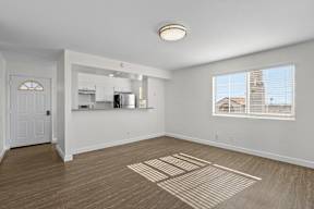 A room with a white door and a window with blinds.
