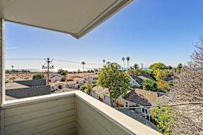 A view from a balcony overlooking a residential neighborhood.