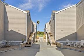 A sunny day at a residential complex with a palm tree in the background.