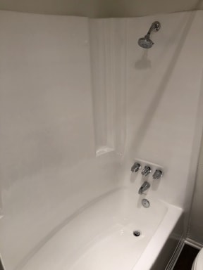 a white bath tub sitting next to a white sink
