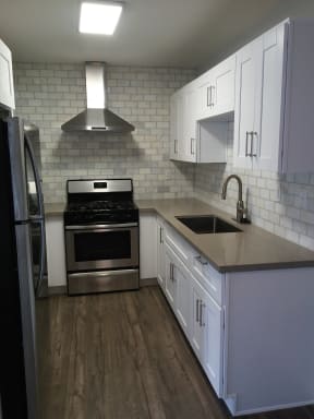 Updated kitchen with granite countertops and  marble back splash at Solara Apartments.