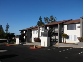 Parking area and view of appartment buildings at Solara Apartments in Fallbrook, CA.