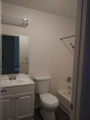 Bathroom with white cabinets at La Costa Seashore Apartments in Carlsbad, CA.