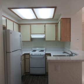 Kitchen with lots of cabinets and light at La Costa Seashore  Apartments.