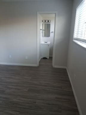 Bathroom with white cabinets and sink at Tulip Street Apartments in Escondido, California.