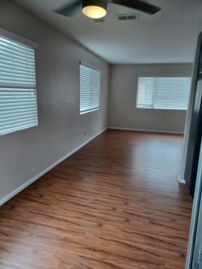 Lots of windows dining area and living room at Juniper Street Apartments in Escondido, California.