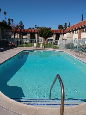 Inviting swimng pool and sun deck at Magnolia Apartments in Riverside, California.