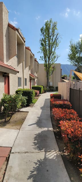 Landscaped walkways between buildings at Sierra Vista Apartment Homes in Lake Elsinore, California.