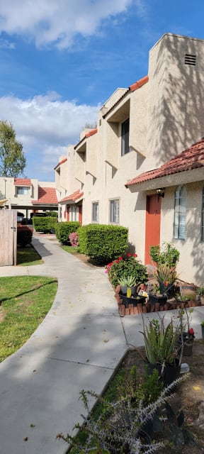 Garden lined apartment walkway at Sierra Vista Apartment Homes in Lake Elsinore, California.