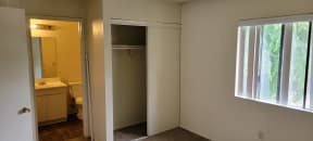 Large closet and private bathroom in carpeted bedroom at Magnolia Apartments in Riverside, California.