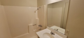 Tub and shower in ensuite unit at Magnolia Apartments in Riverside, California.