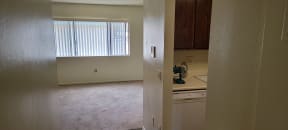 Hallway view of kitchen enterance and front room at Magnolia Apartments in Riverside, California.