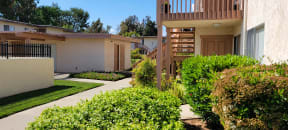 Beautiful landscaping outside apartment units at Plaza Verde Apartments in Escondido, California.