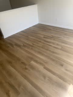 A room with a wooden floor and white walls.