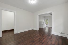 A room with wooden floors and white walls.