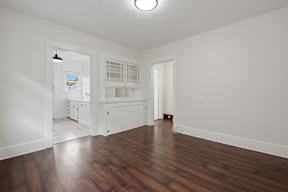 A room with wooden floors and white walls.