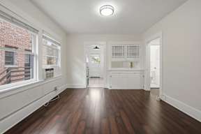 A room with wooden floors and white walls.