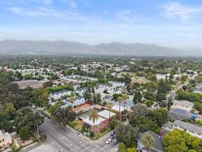 A view of a residential area with houses and trees.