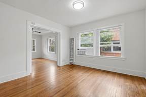 A room with wooden floors and white walls.
