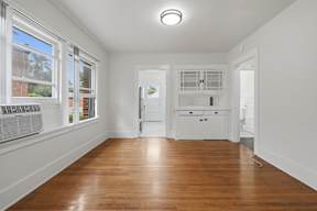 A room with wooden floors and white walls.