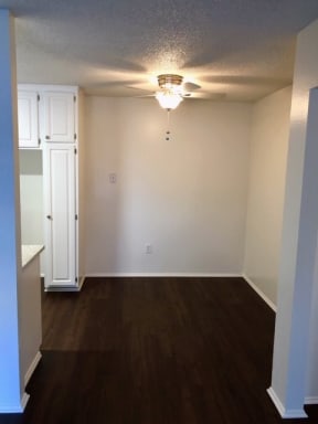 an empty room with a ceiling fan and a closet