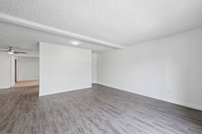 A room with a ceiling fan and a light fixture.