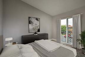 A bedroom with a large bed, a nightstand, and a painting on the wall.