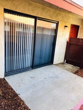 a garage with a black door and a brown door