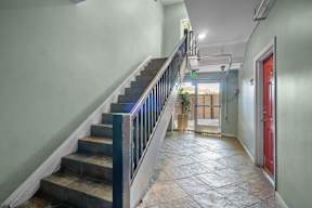 A hallway with a staircase.