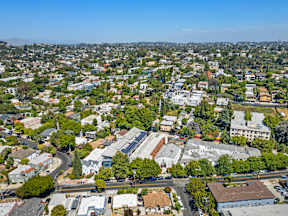 A bird's eye view of a residential area with houses and trees.