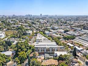 A bird's eye view of a residential area with a large building in the center.