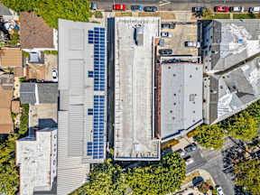 A building with a large solar panel on the side.