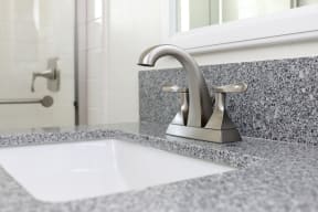 Upgraded bathroom fixtures in apartment at Harbor Villa Apartments in San Diego, California.
