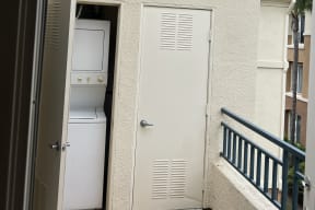 In-unit washer/dryer off balcony at Carmel Heights Apartments in San Diego, California.