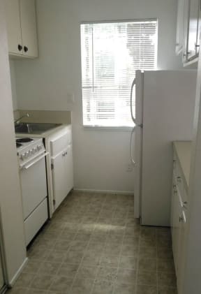 Newly remodeled all white kitchen at Dubuque Apartments in Oceanside, CA.