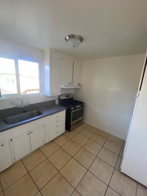 Kitchen with natural light and spacious cabinets at Edison Apartments in Burbank, California.