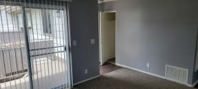 Living room view of enterance and front closet at Grand Oaks Apartments in Lake Elsinore, California.