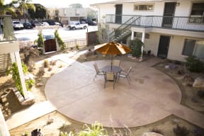 Patio sitting area in courtyard at Harbor Villa Apartments in  San Diego, California.