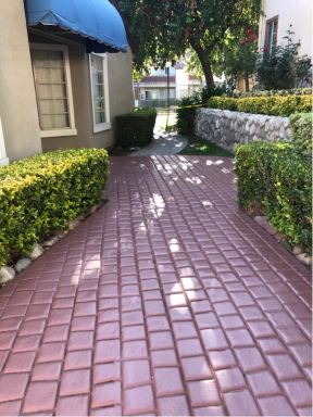 Quaint brick pathways and garden walls at Northwood Apartments in Upland, California.