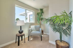 Carpeted bedroom /study with large windows at Villa Grande Apartments in San Diego, California.