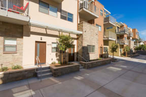 Courtyard and parking area at Villa Grande Apartments in San Diego, California.