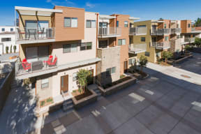 Aerial view of balconies and courtyard near parking at Villa Grande Apartments in San Diego, California.