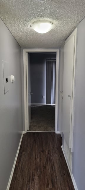 Bedroom hallway with lots of closet space at Grand Oaks Apartments in Lake Elsinore, California.