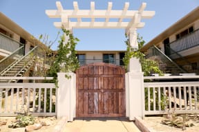 Wooden gate enterance to Harbor Villa Apartments in San Diego, California.