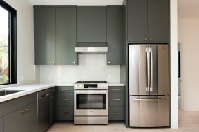 Spacious kitchen cabinets and stainless steel upscale appliances in kitchen at 633 Palms Blvd. apartment in Venice, California.