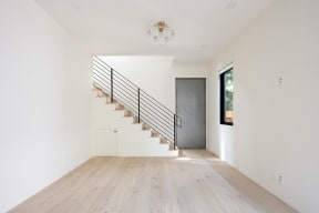 Stairway in living room with wood plank style flooring at 633 Palms Blvd. in Venice, California.
